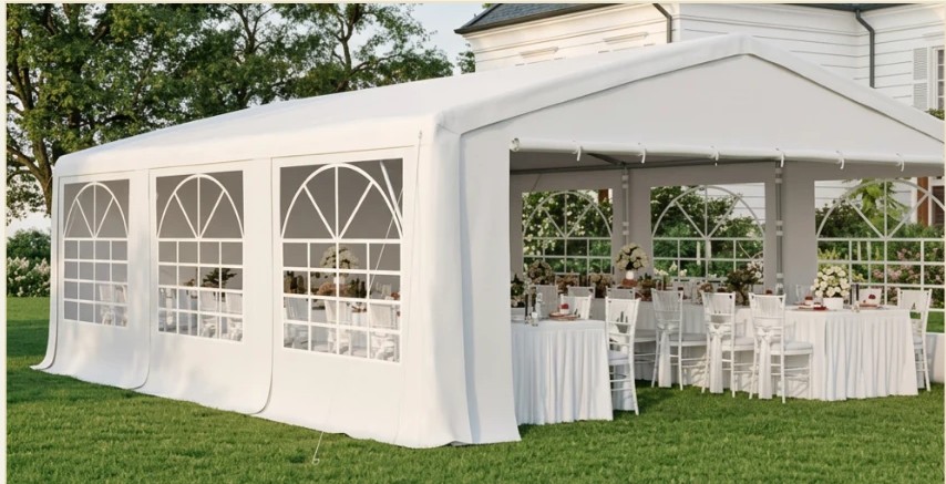 Enclosed white event pavilion tent with window walls and a set reception table inside